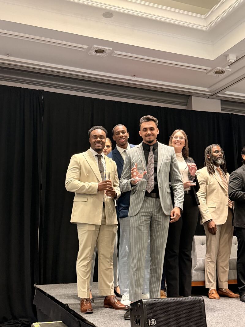 Mainline Strategies team members receiving recognition on stage