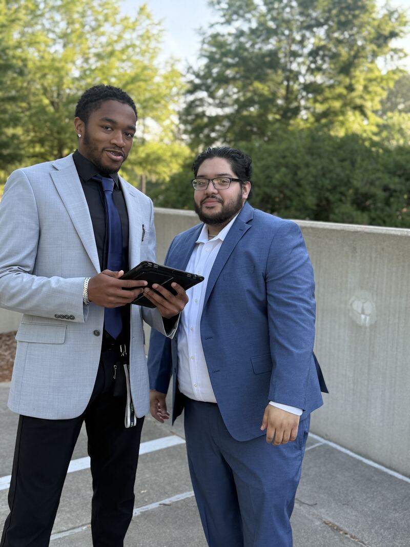Two Mainline Strategies representatives reviewing customer results on a tablet