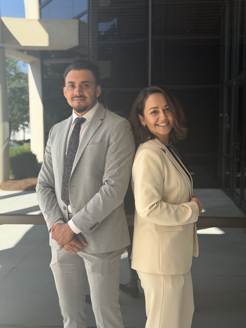 Two Mainline Strategies professionals standing back to back outside the office