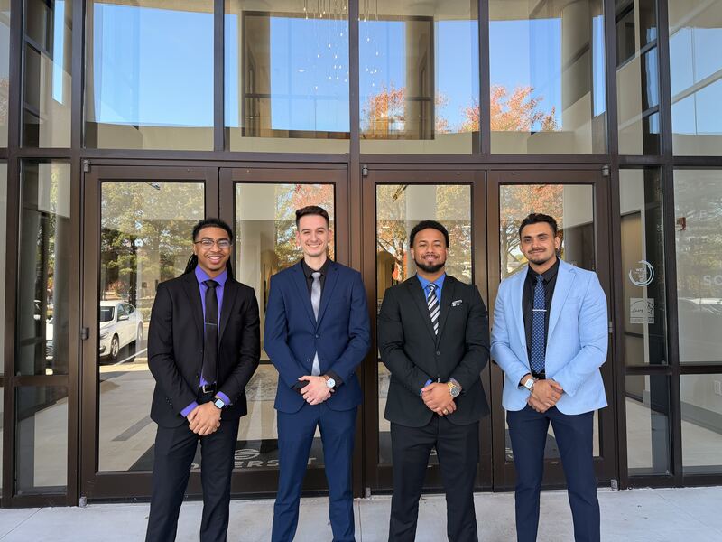 Four Mainline Strategies team members outside the entrance of the Virginia Beach office